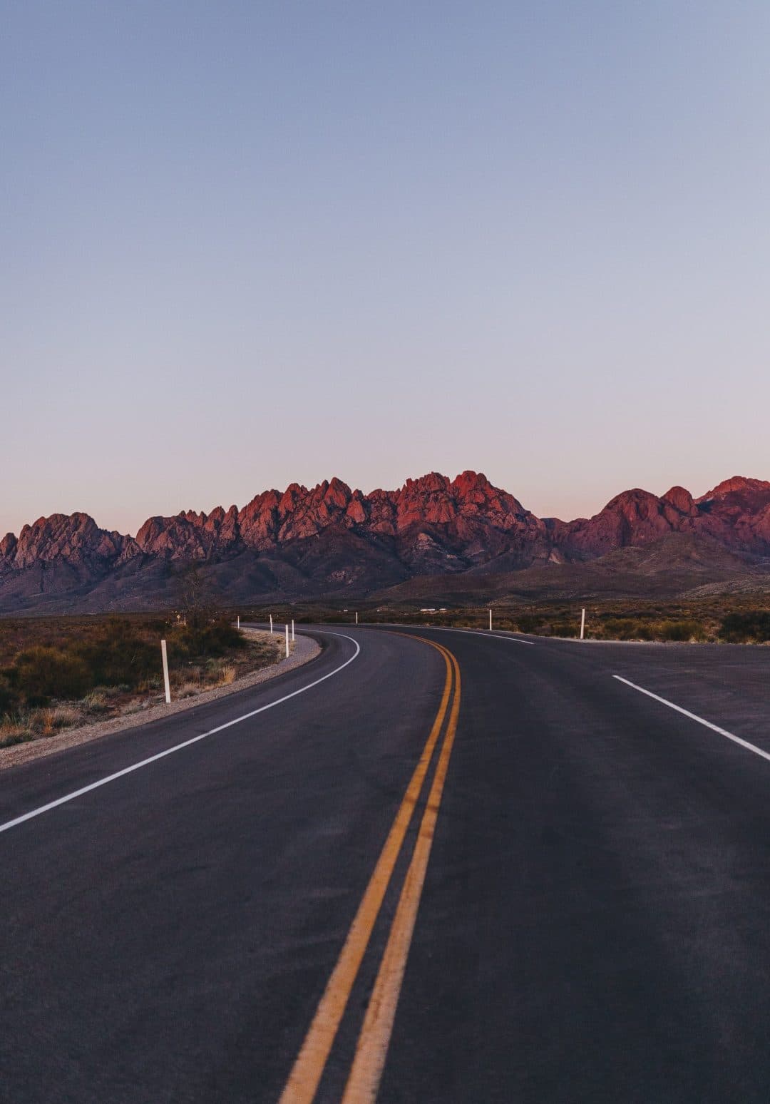 A higway driving towards a mountain range